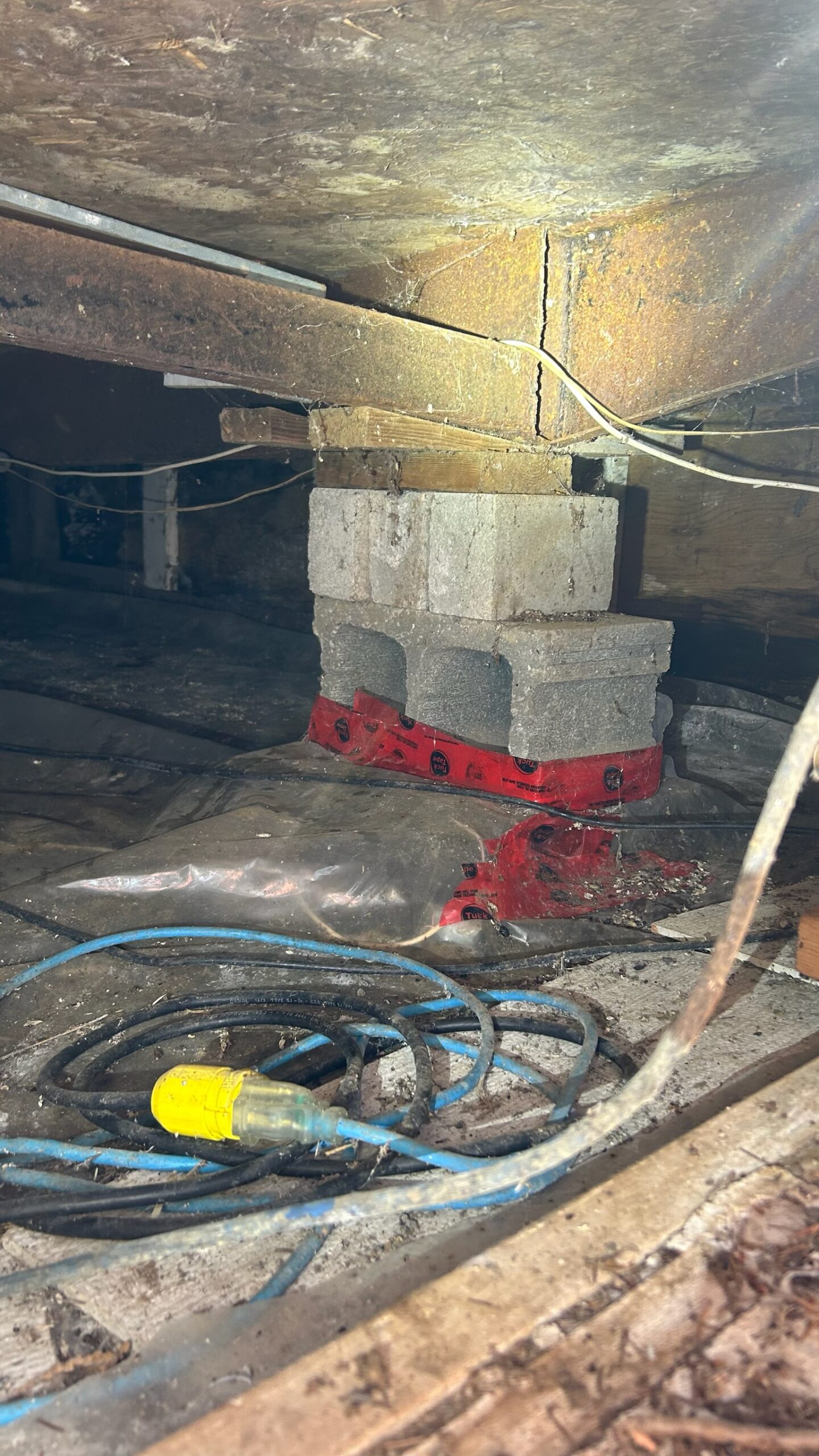 Torn belly wrap and insulation under mobile home crawlspace in Victoria BC exposing pipes and framing