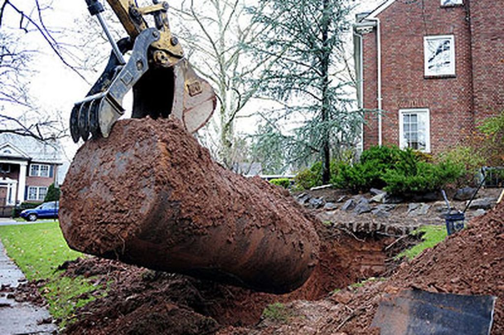 Excavation and removal of buried oil tank from residential yard on Vancouver Island