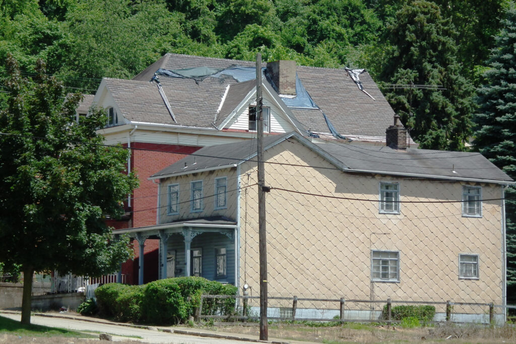 House with patterned asbestos-cement shingle siding in a documented example outside British Columbia